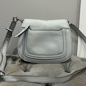 Marc Jacobs Empire City leather messenger crossbody bag in a light grey color.